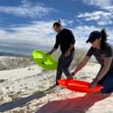 Sergio and Tabby line up for a sled race at White Sands